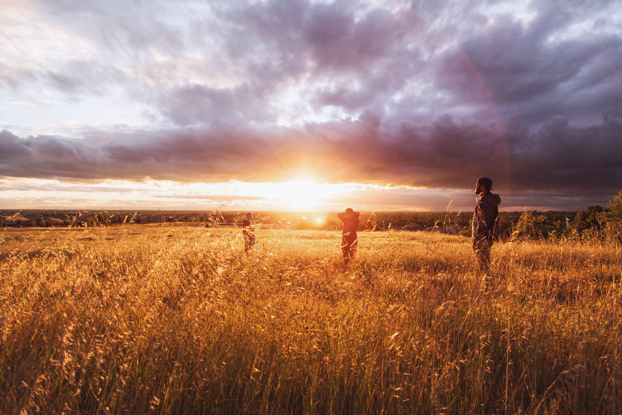 Man Standing on Brown Fields during Sunset